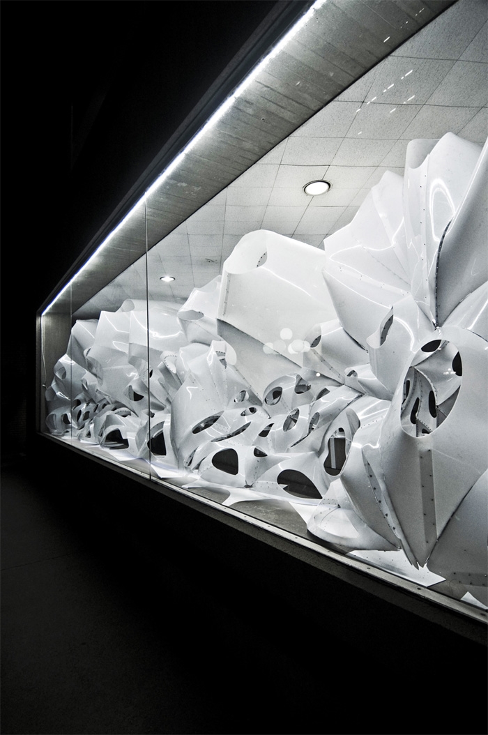 An installation that populates the corridor spanning by skylar tibbits