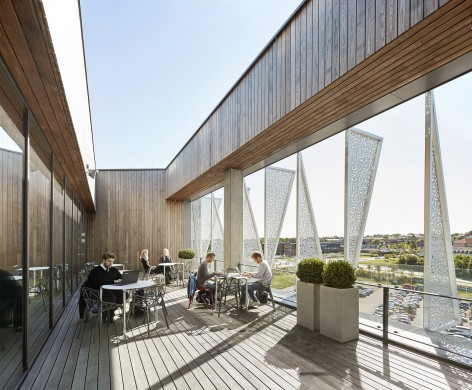 With its triangular shape, Campus Kolding of University of Southern Denmark creates a significant new landmark in Kolding. The building is located in Kolding, Denmark, and designed by Henning Larsen Architects. Photo by Hufton + Crow.