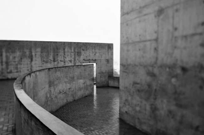 21- A solitary rough concrete monument rises from destruction, China by West-line studio