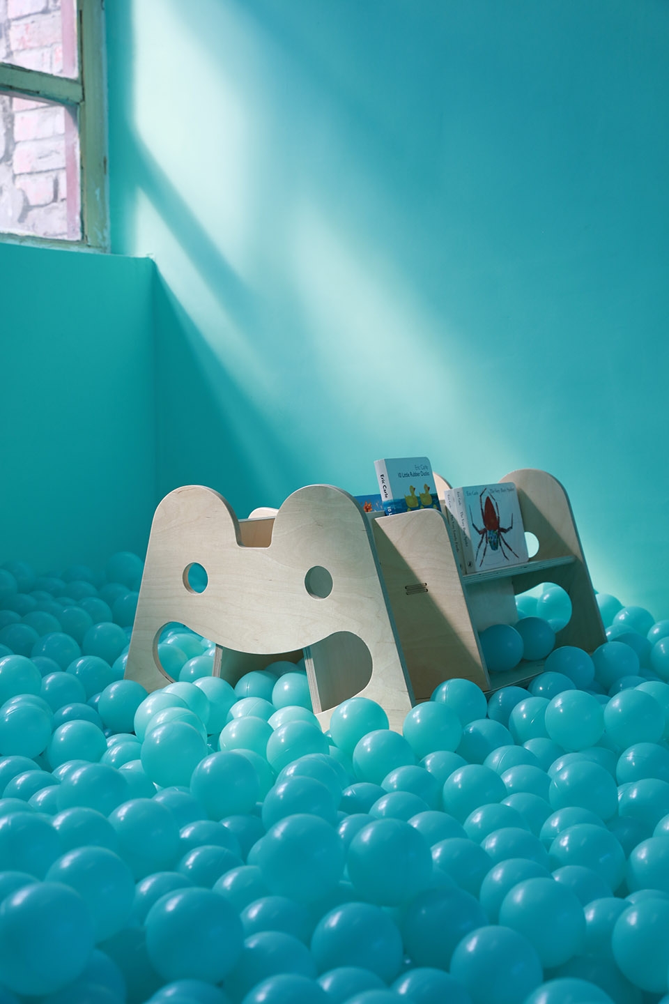 a bookshelf designed for kids huplay dot architects