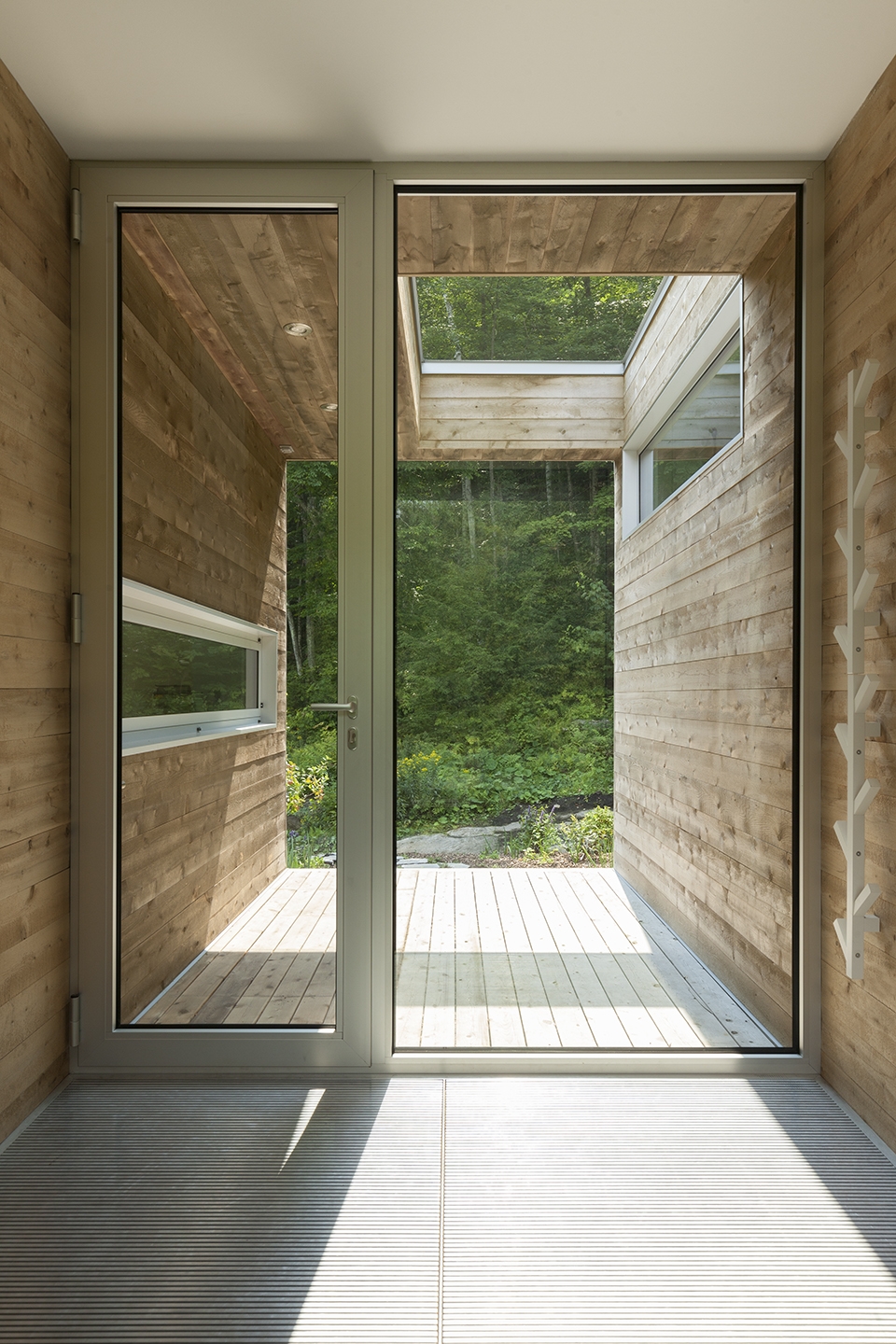 the small outdoor vestibule has a window into the kitchen