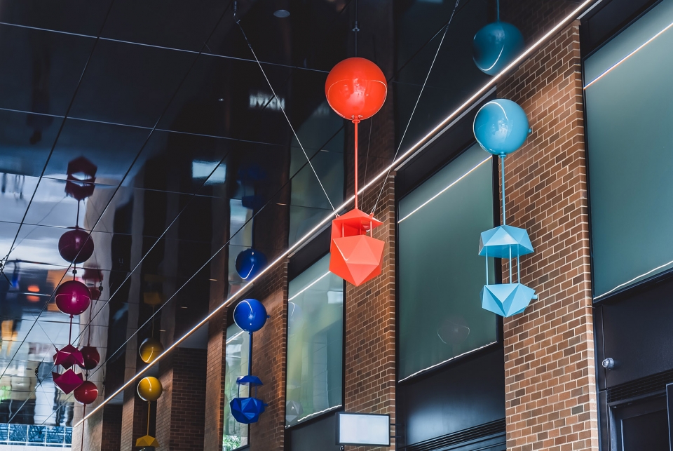 delicate and playful sculptures hang mid air in pedestrian walkway by uap