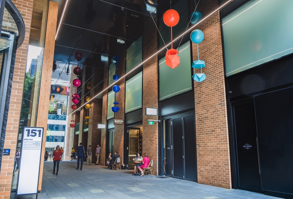 delicate and playful sculptures hang mid air in pedestrian walkway by uap