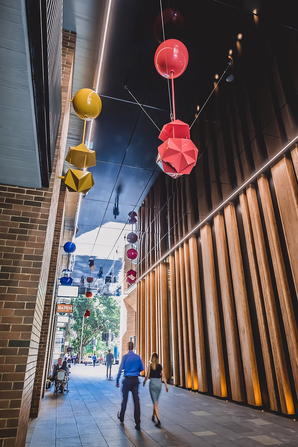 delicate and playful sculptures hang mid air in pedestrian walkway by uap