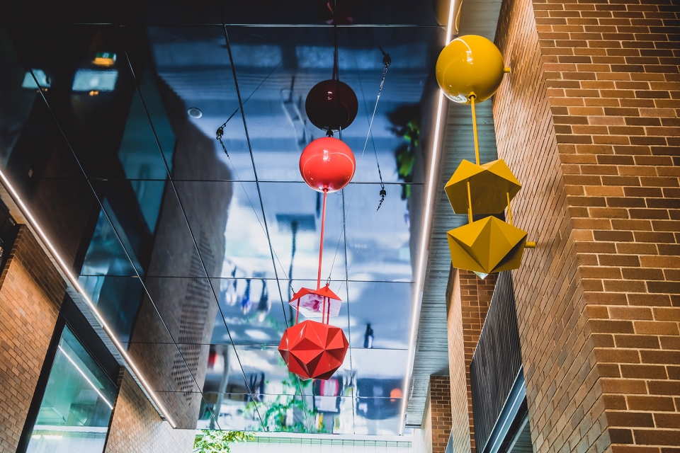 delicate and playful sculptures hang mid air in pedestrian walkway by uap
