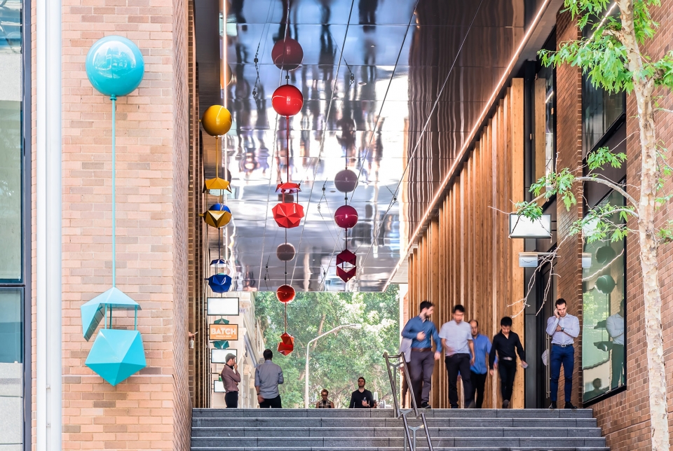delicate and playful sculptures hang mid air in pedestrian walkway by uap