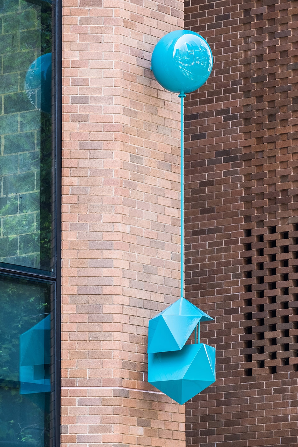 delicate and playful sculptures hang mid air in pedestrian walkway by uap
