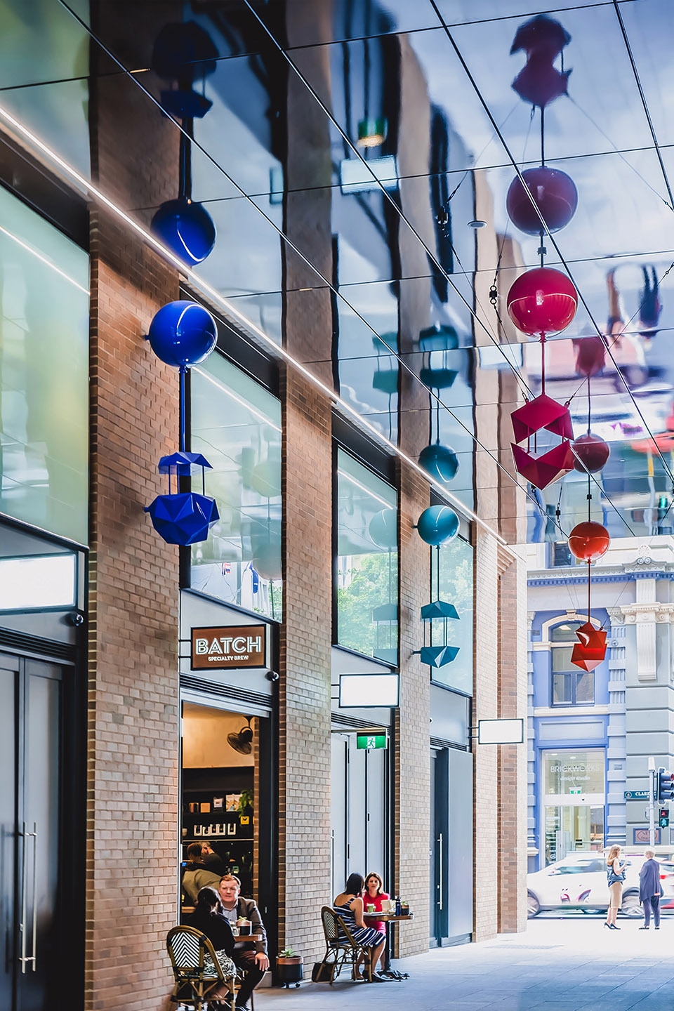 delicate and playful sculptures hang mid air in pedestrian walkway by uap