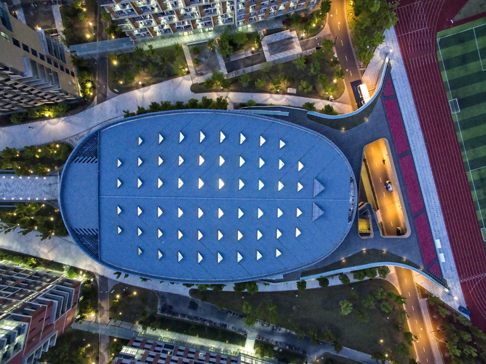 a living fish swimming in the campus design of the sports hall of shanghai university of science and technology china by tjad