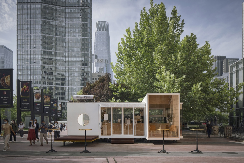 wandering metal hands coffee drives camping coffee car into china world trade center beijing by daga architects