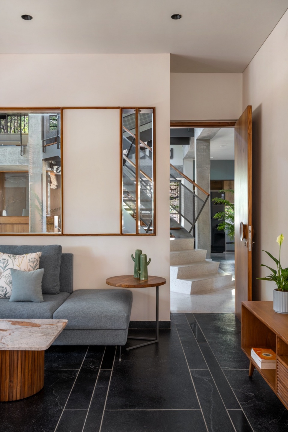 Formal living room opening out to the sunk seating terra kota house by terra firma architects