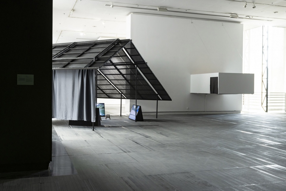 a settlement with sloping roofs exhibition design by atelier waterside