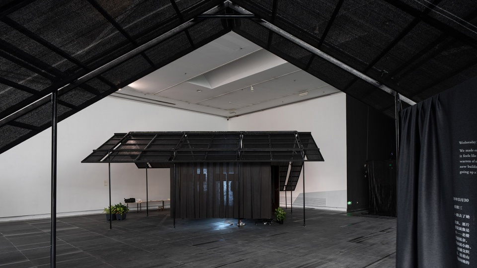 a settlement with sloping roofs exhibition design by atelier waterside