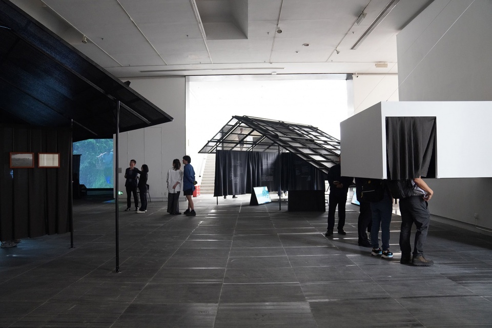 a settlement with sloping roofs exhibition design by atelier waterside