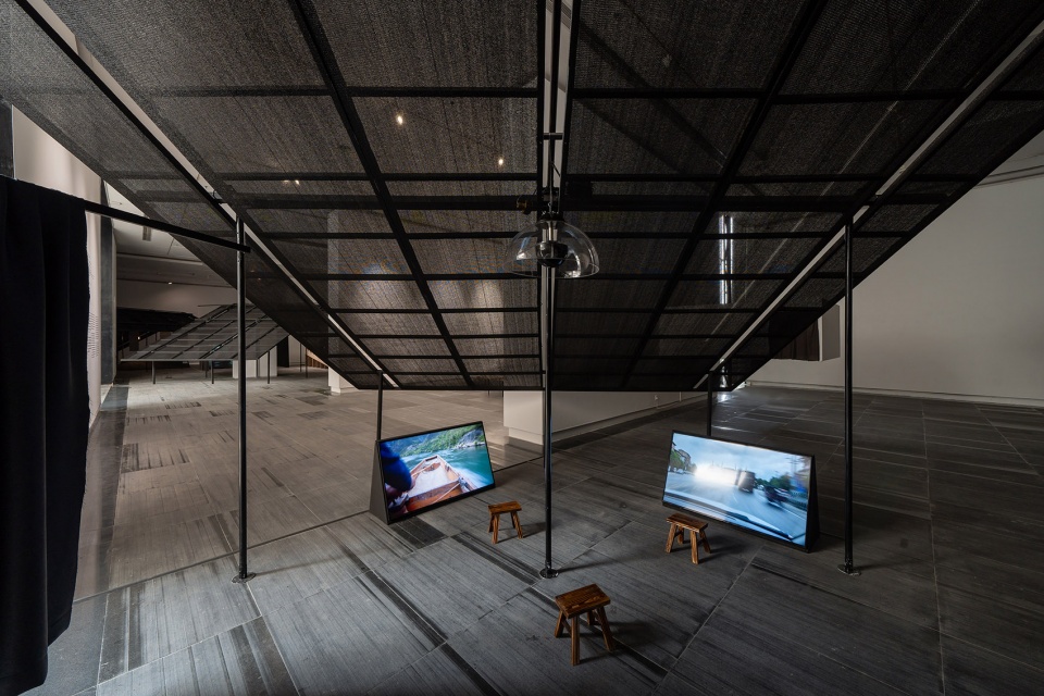 a settlement with sloping roofs exhibition design by atelier waterside