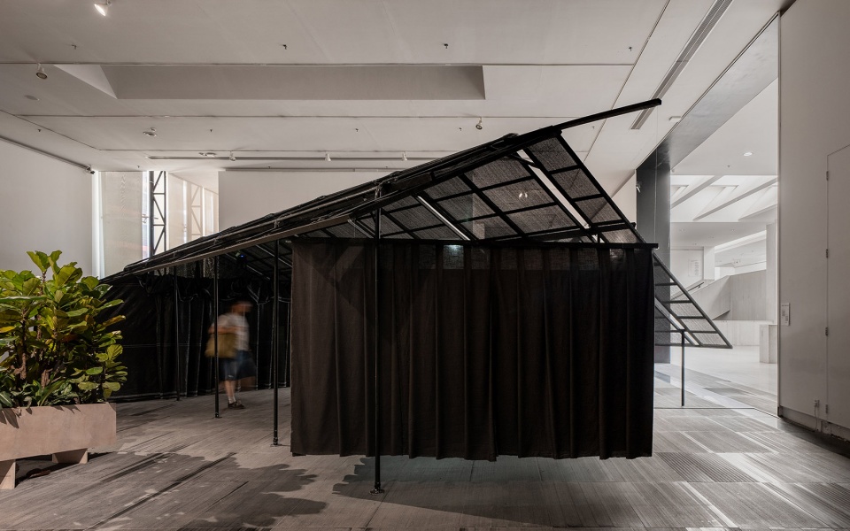 a settlement with sloping roofs exhibition design by atelier waterside