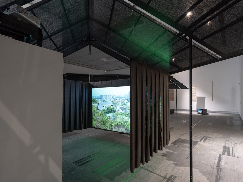 a settlement with sloping roofs exhibition design by atelier waterside