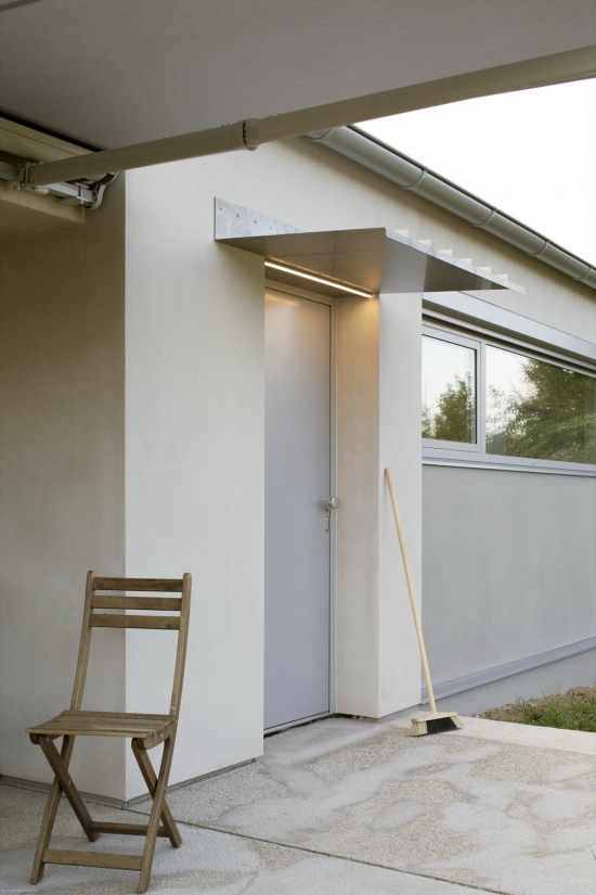 modular house with a sloping facade by papundekl architects